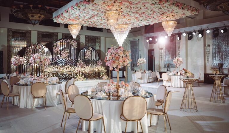A ballroom set for a wedding with a floral ceiling installation, One&Only Royal Mirage