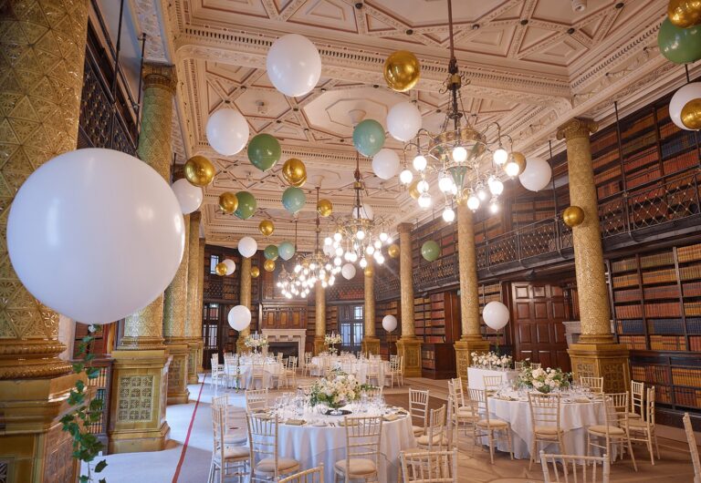 The Gladstone Library dressed for a wedding with balloons and round tables, One Whitehall Place