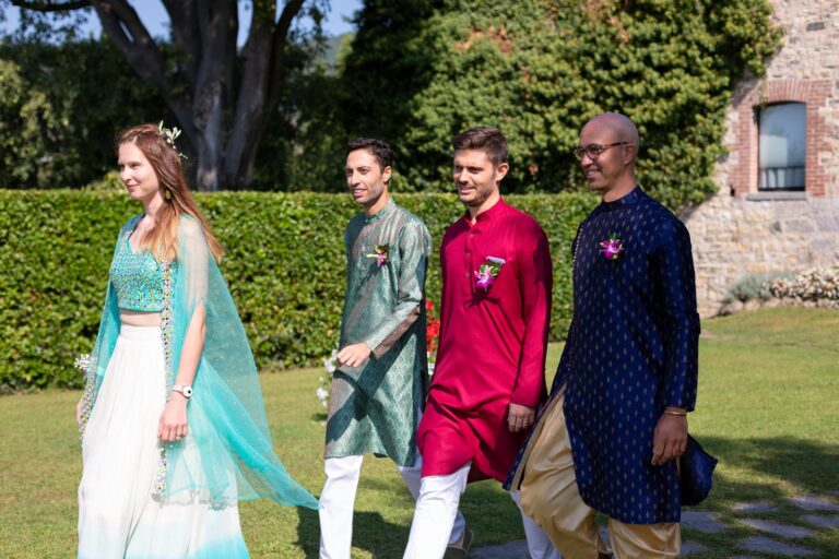 Guests in Indian dress crossing the lawn at a Hindu wedding in Como, Ordine della Giarrettiera