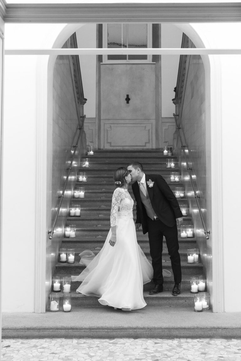 A kiss on a candlelit staircase at Villa del Grumello on Lake Como, black and white, Ordine della Giarrettiera