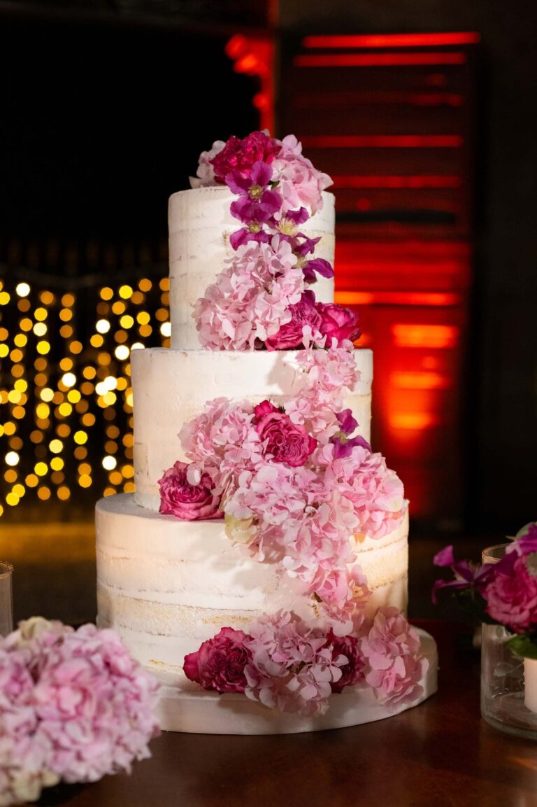 A tiered wedding cake dressed in pink flowers, Caterina and Rashed's wedding at Villa Semenza, Ordine della Giarrettiera