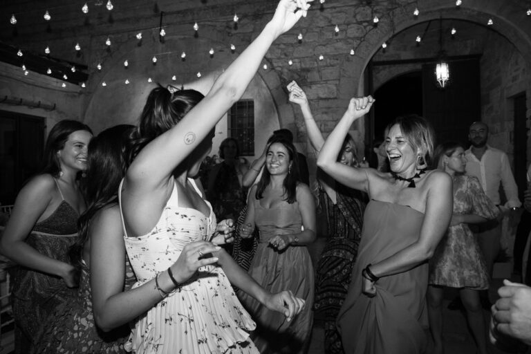 Friends dancing under the lights at the Sicilian wedding, black and white, Ordine della Giarrettiera