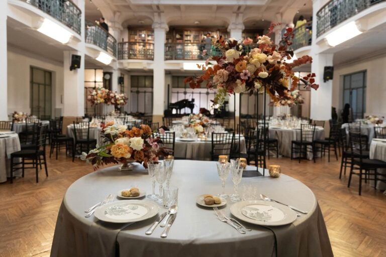Round tables set among the bookshelves of the Centro Filologico Milanese for a winter civil union, Milan, Ordine della Giarrettiera