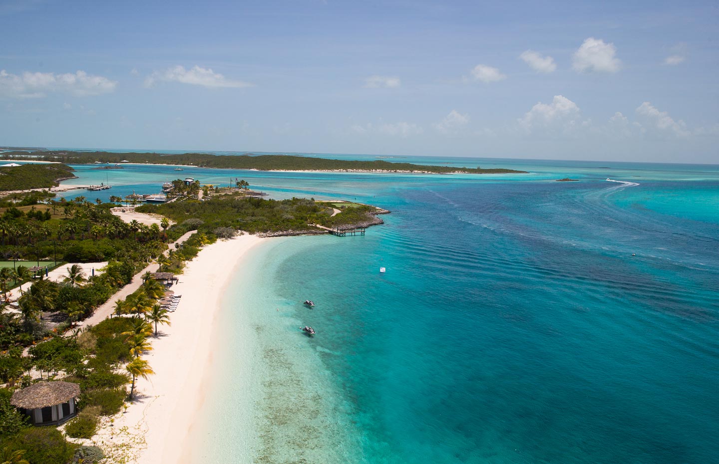 Aerial view of the island, its white-sand beach and the villas among the greenery, Over Yonder Cay