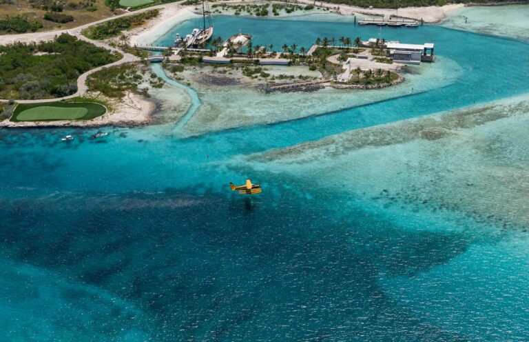 Aerial view of the island with the golf course, marina and turquoise shallows, Over Yonder Cay