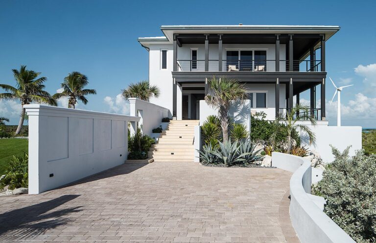Villa entrance with a stone staircase beneath palms, Over Yonder Cay