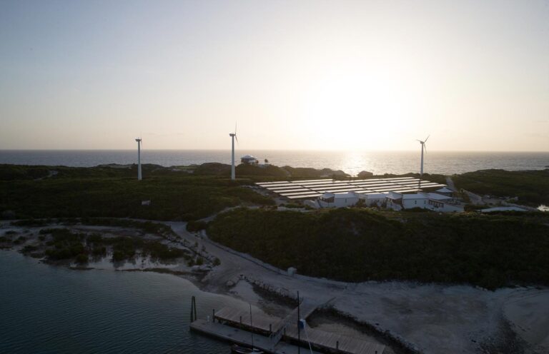 Wind turbines on the ridge at sunset, part of the island renewable energy system, Over Yonder Cay
