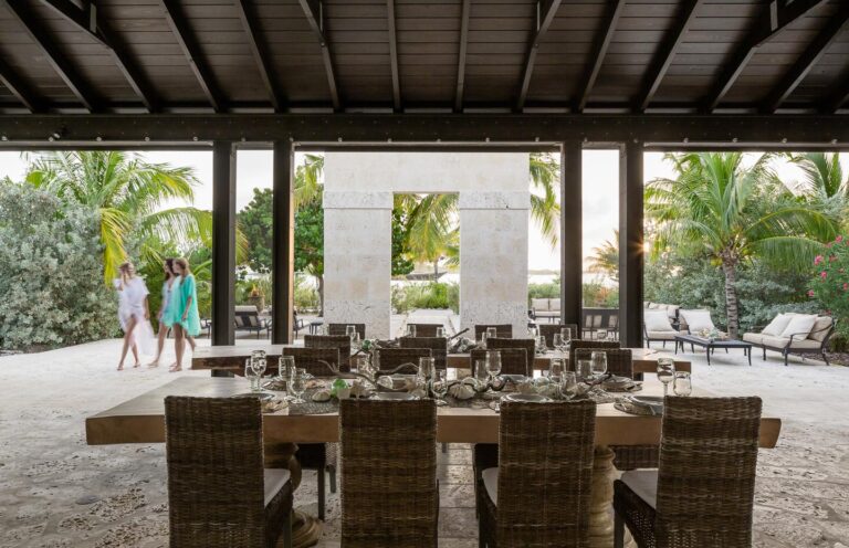 Long wooden dining table in an open-sided pavilion, Over Yonder Cay