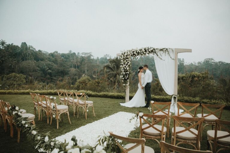A couple at a draped ceremony arch overlooking the valley, Padma Resort Ubud