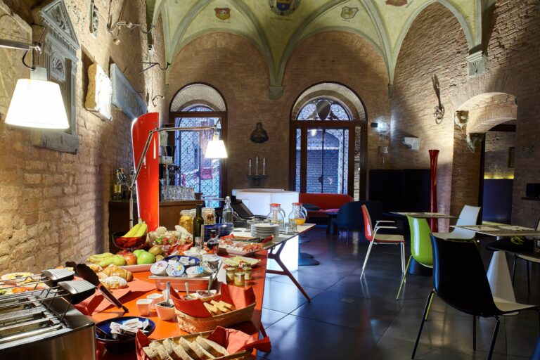 A vaulted breakfast and reception room set with the morning spread, Palazzetto Rosso