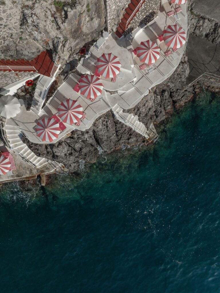 The Clubhouse by the Sea seen from above, with parasols on the rocks, Palazzo Avino