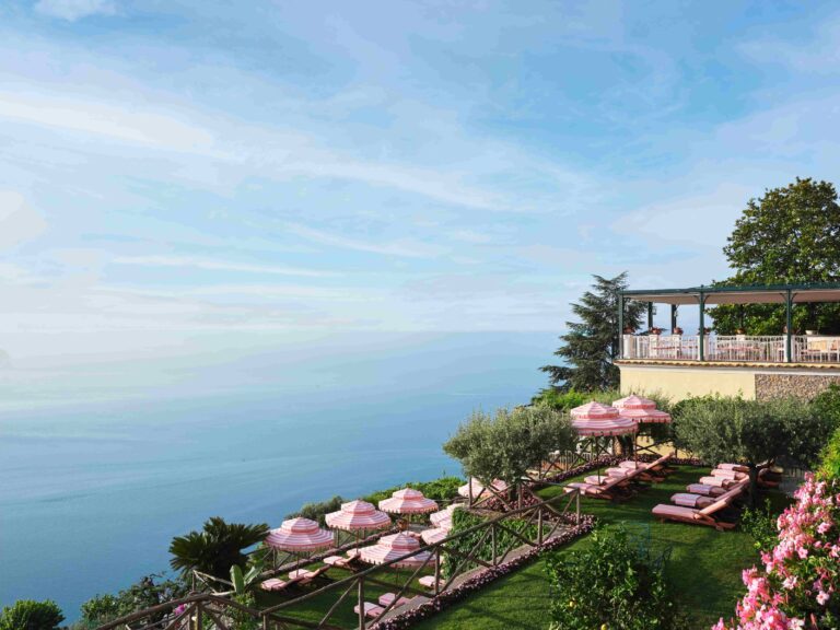 The hotel on the cliff above the sea, with the garden terrace and pink loungers, Palazzo Avino