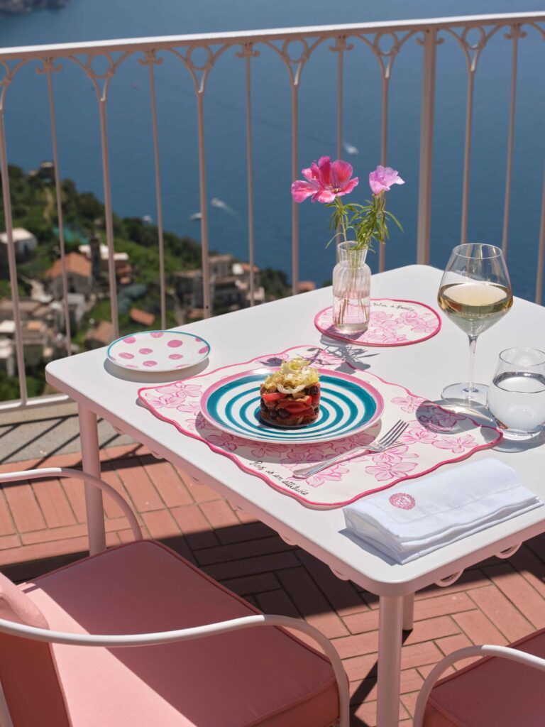 A terrace table set with plates and flowers, Palazzo Avino