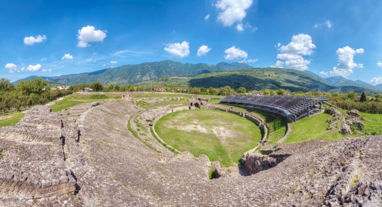 The Roman Amphitheatre of Avella: an aerial panorama above the arena floor, with the Apennine foothills beyond, Palazzo Ducale di Avella e Anfiteatro Romano