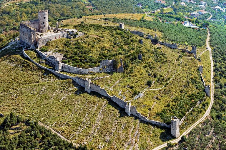 The Norman Castle of Avella from the air, its medieval walls stretching across the hilltop above the town, Palazzo Ducale di Avella e Anfiteatro Romano