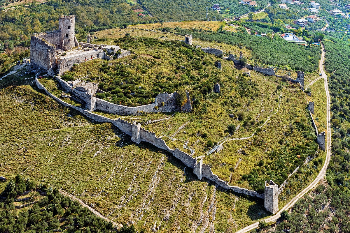 The Norman Castle of Avella from the air, its medieval walls stretching across the hilltop above the town, Palazzo Ducale di Avella e Anfiteatro Romano