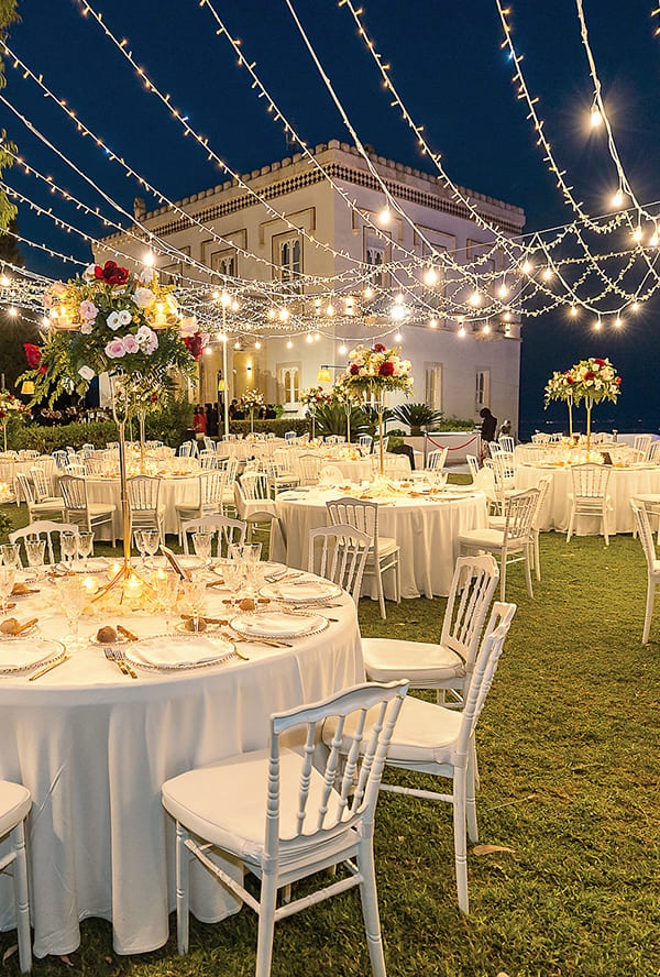 A lawn reception under festoon lights in front of a villa, Taormina
