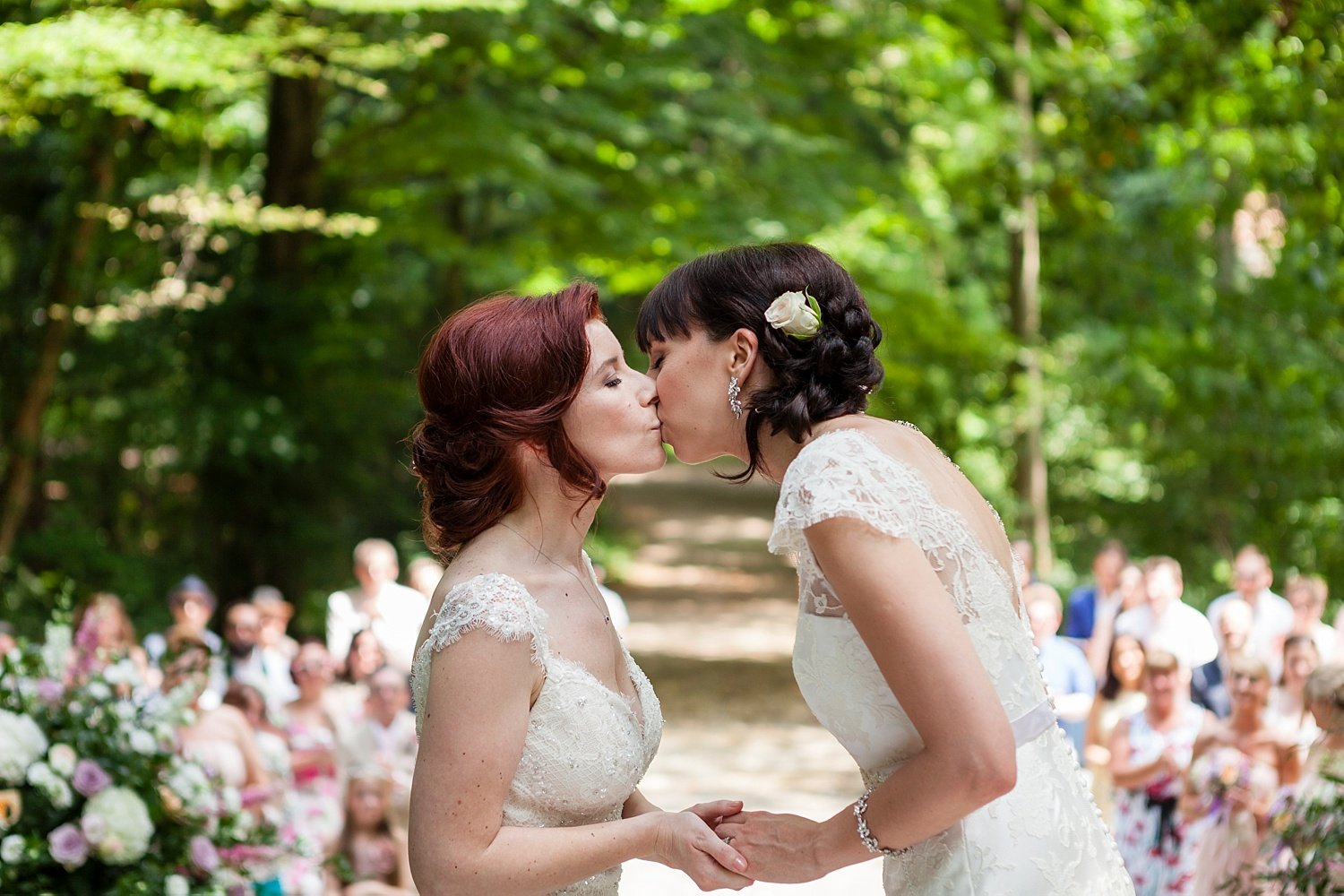 Two brides kiss during their woodland ceremony at Frassanelle, near Venice, Paola De Paola Photography