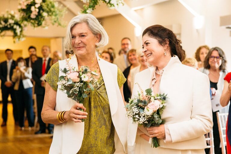Two brides walk back down the aisle together at Stoke Place, Paola De Paola Photography