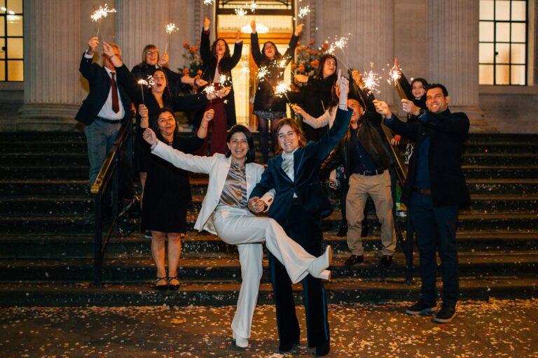 Sparklers instead of confetti as two brides leave their ceremony at Old Marylebone Town Hall, Paola De Paola Photography