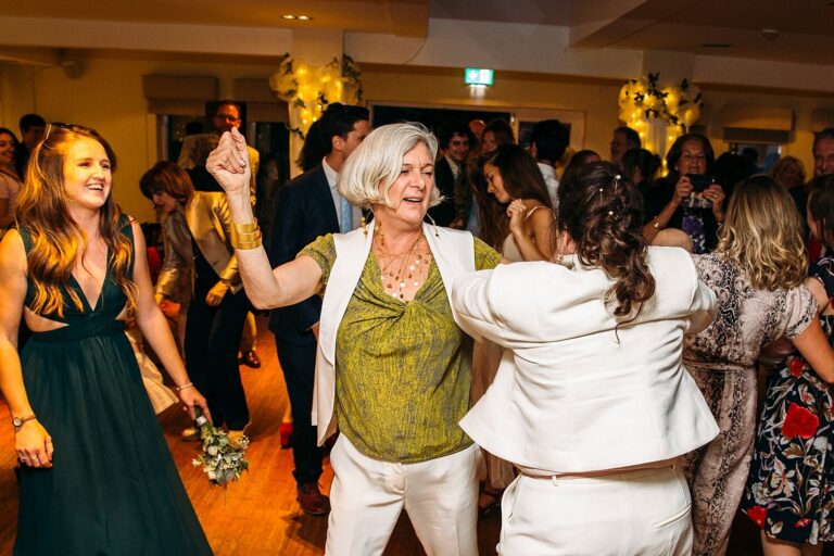 The brides and their guests on the dance floor at Stoke Place, Paola De Paola Photography