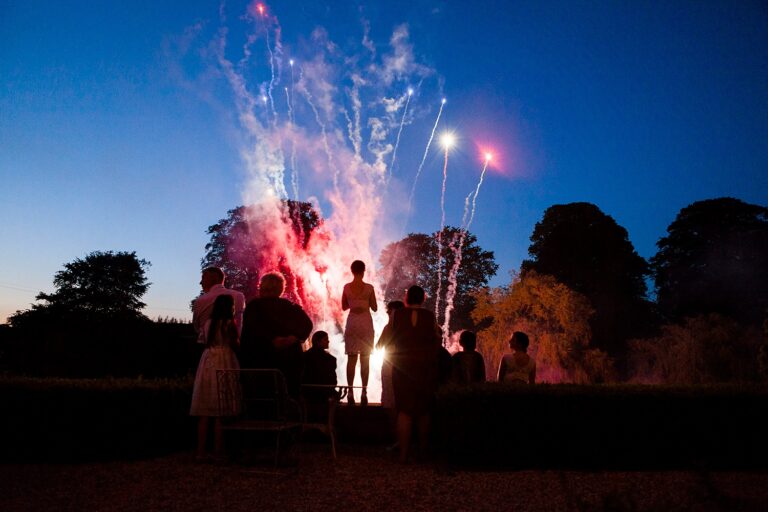 Guests watch fireworks against the night sky at Ston Easton Park, Somerset, Paola De Paola Photography