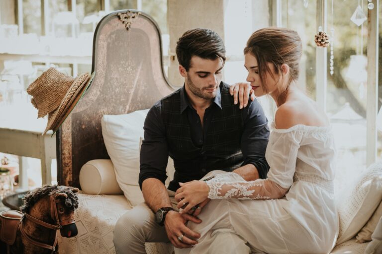 Couple seated together in a styled indoor wedding scene, Paola Giancola Makeup