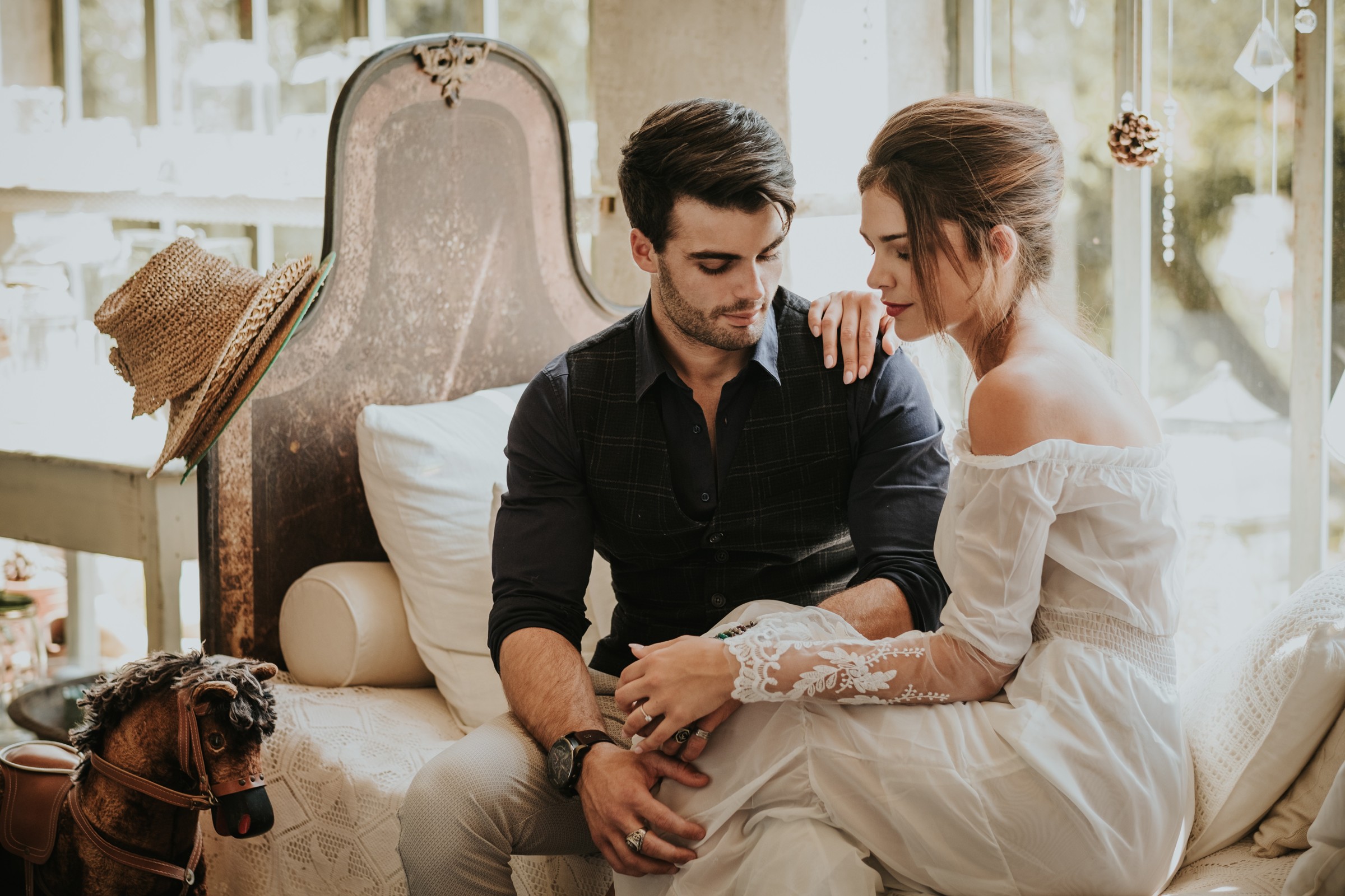 Couple seated together in a styled indoor wedding scene, Paola Giancola Makeup