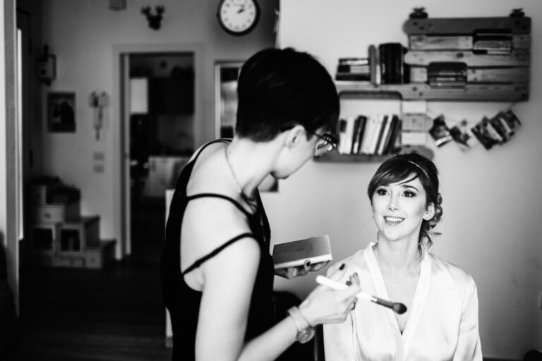 Black and white view of a bride having her makeup applied at home, Paola Giancola Makeup
