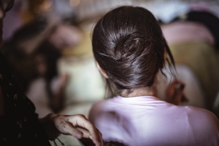 Close view of a low chignon on a bride, with bridesmaids out of focus, Paola Giancola Makeup