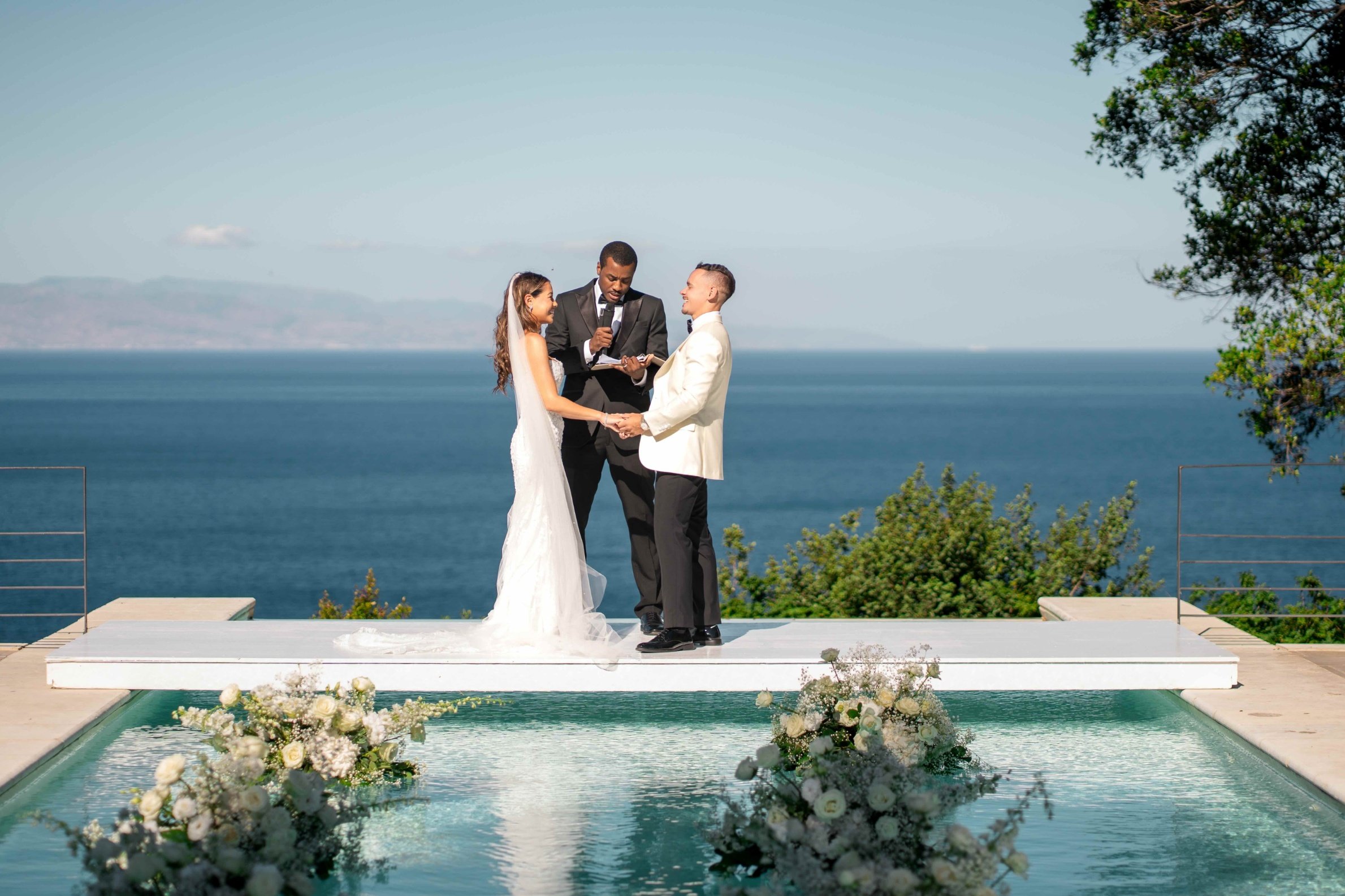 The vows on a floating platform over an infinity pool, the Ionian Sea behind, Villa Mon Repos, Taormina, Paola Lapi Luxury Event