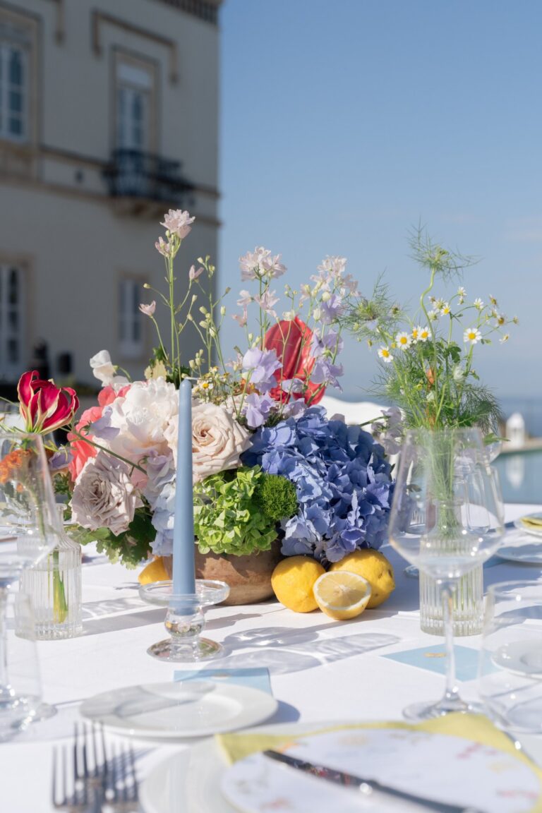 Table flowers in blue and pink with lemons, the sea beyond, Villa Mon Repos, Taormina, Paola Lapi Luxury Event