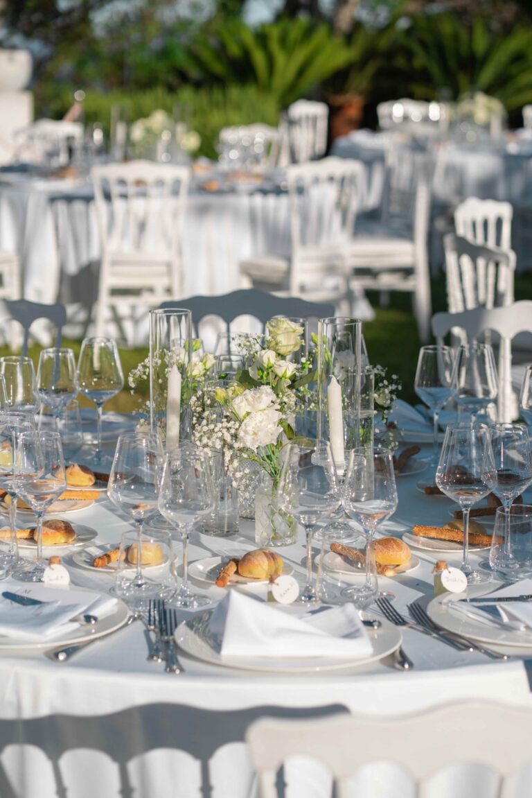 A reception table laid in white with glassware and low flowers, Villa Mon Repos, Taormina, Paola Lapi Luxury Event