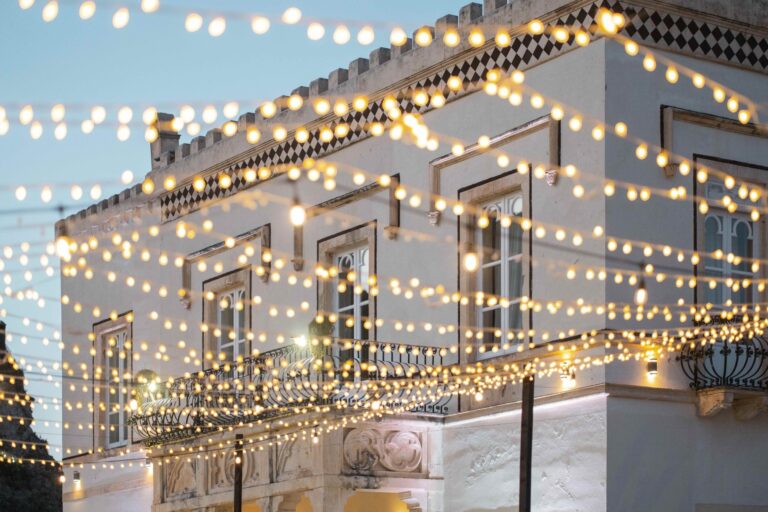 The crenellated villa front hung with strings of lights for the evening, Villa Mon Repos, Taormina, Paola Lapi Luxury Event