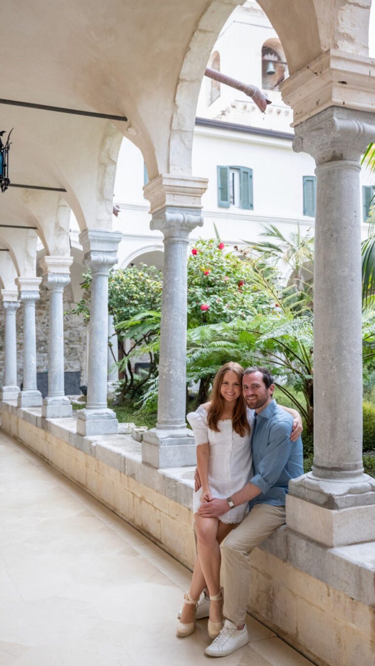 A couple seated in the arcaded cloister at San Domenico Palace, Taormina, an editorial engagement shoot, Paola Lapi Luxury Event