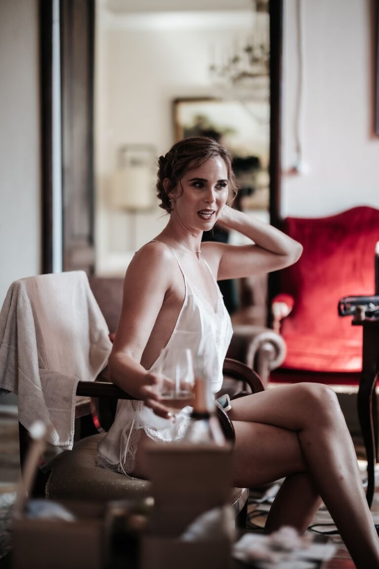 Ciara in the room before it starts, off the shoulder of the mirror, holding the glass, Paolo Cicognani Weddings & Events
