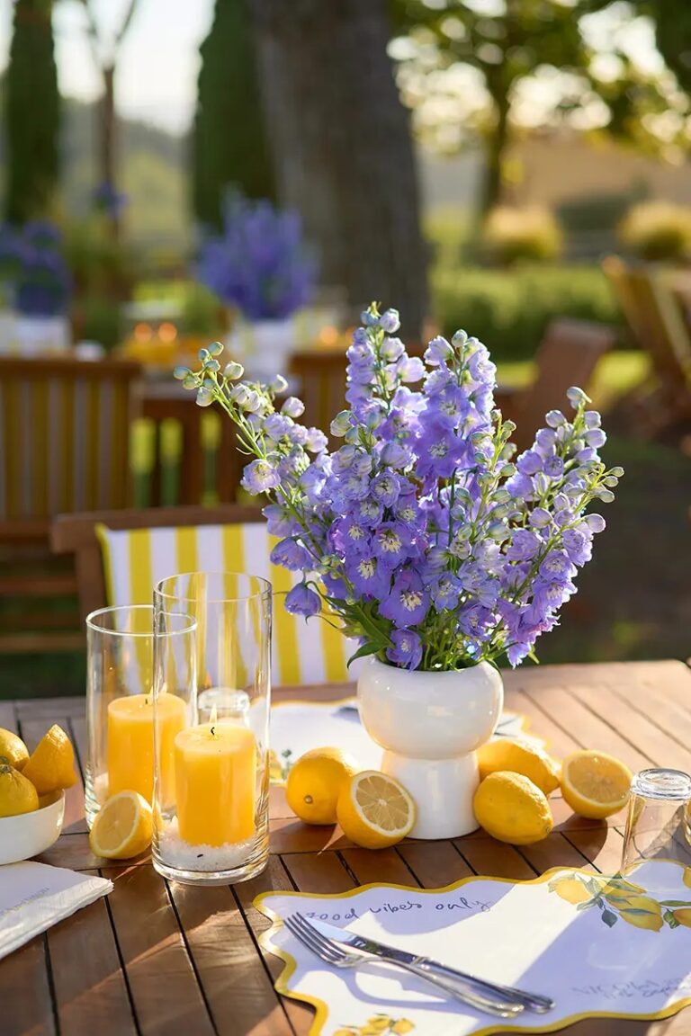 Delphiniums, halved lemons and yellow pillar candles in the last of the sun, Paolo Cicognani Weddings & Events