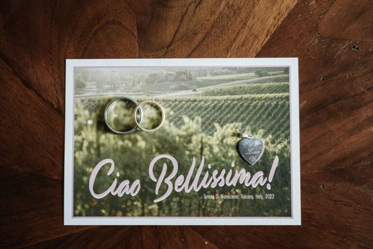 The card that reads Ciao Bellissima, Tenuta Di Monaciano, Tuscany, Italy, 2022, and two rings on it, Paolo Cicognani Weddings & Events