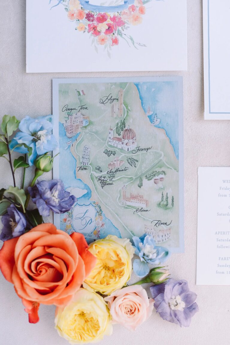 The hand-painted map of the route, Firenze to Roma, laid among coral roses and delphiniums, Paolo Cicognani Weddings & Events