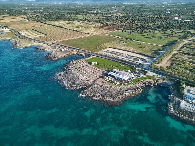 The coast from higher up, the water turning over the rock, olive groves inland, Paolo Cicognani Weddings & Events