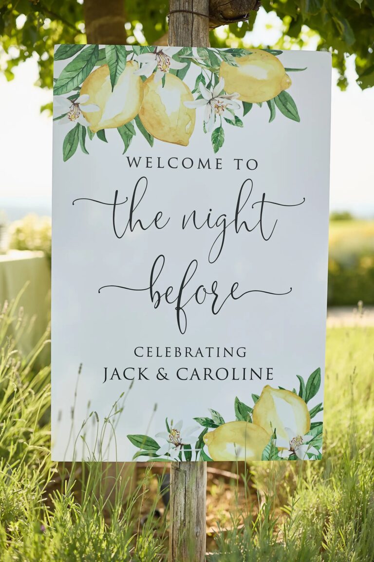 The welcome sign in the long grass, lemons painted on it, for Jack and Caroline, the night before, Paolo Cicognani Weddings & Events