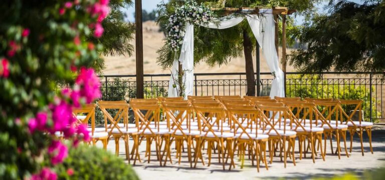 Wooden arch and cross-back chairs set out for a ceremony, Liopetro, Paphos Weddings Made Easy