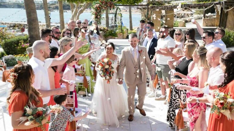 Guests cheering and throwing confetti around the newlyweds, Coral Beach Hotel, Paphos Weddings Made Easy