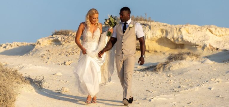 The couple walking across pale sand dunes, Paliomonastiro, Paphos Weddings Made Easy