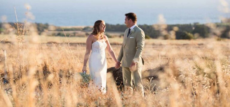 Couple walking through golden grass, Liopetro, Paphos Weddings Made Easy