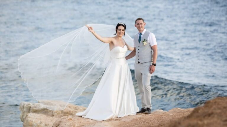 Bride and groom at the water edge with the veil in the wind, Alexander The Great Hotel, Paphos Weddings Made Easy