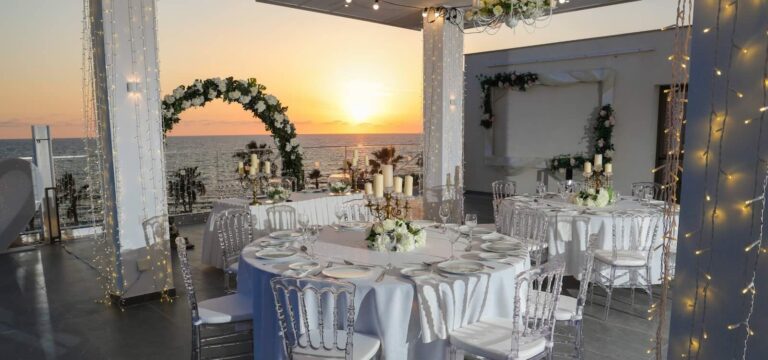 Round table and floral arch at sunset on the terrace, Kefalos Beach, Paphos Weddings Made Easy