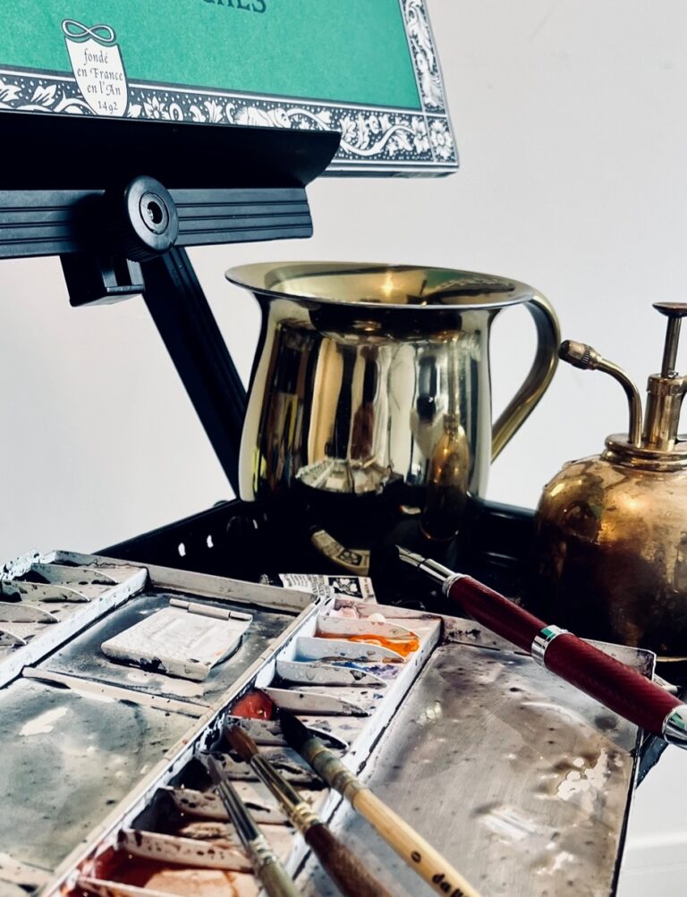 Watercolour palette, brushes and brass water pot on the painting easel, Patrick Heisel Watercolours
