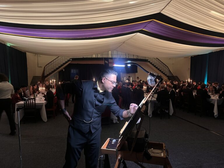 The artist painting live at an evening event in a marquee, Patrick Heisel Watercolours