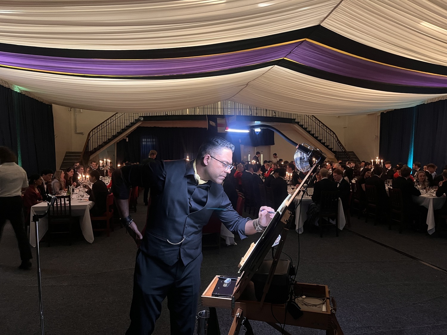 The artist painting live at an evening event in a marquee, Patrick Heisel Watercolours